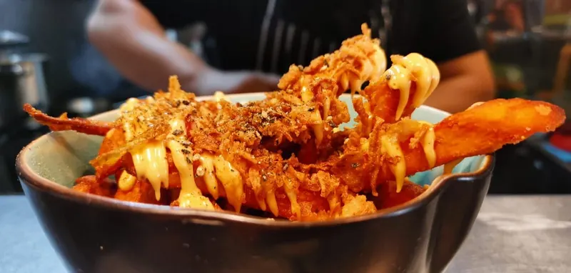 Sweet potato fries with crispy onions and spicy mayo
